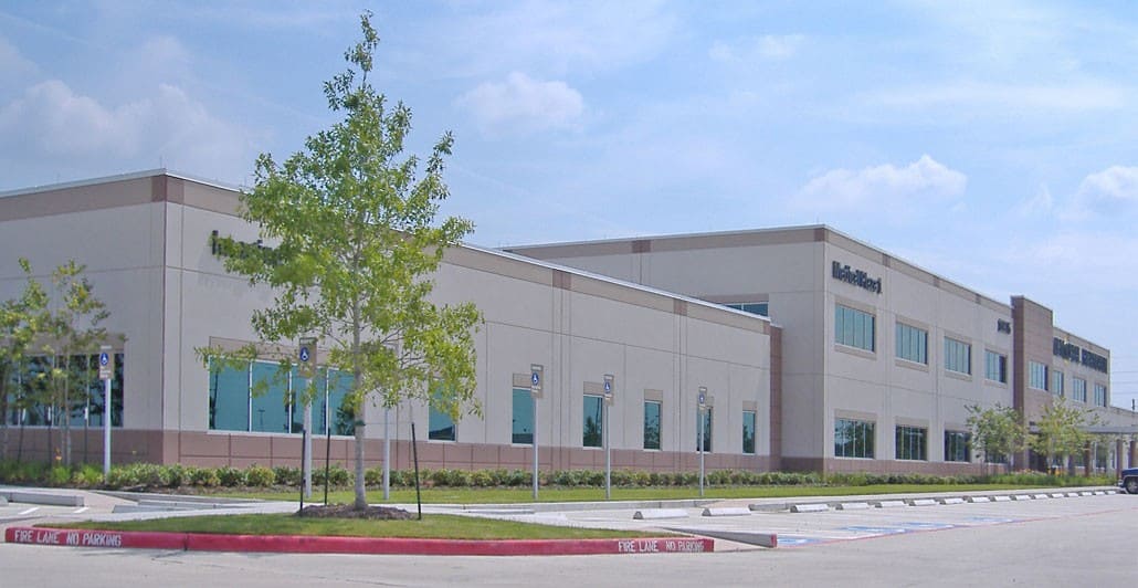 Pearland Medical center exterior building with a tree next to the parking lot.