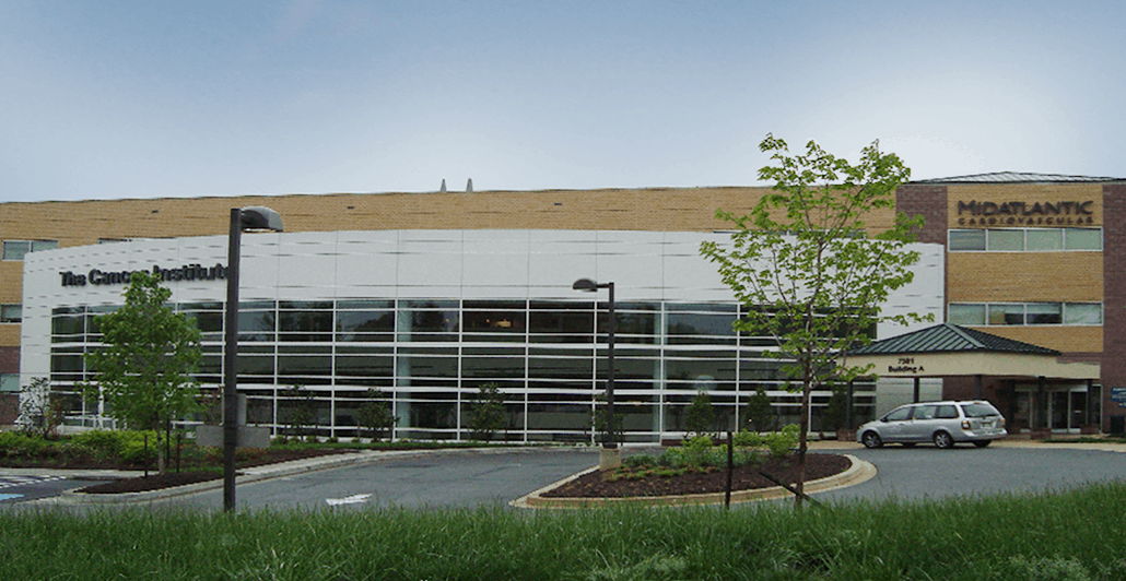 Midatlantic Cardiovascular exterior of building with grass and trees next to the parking lot
